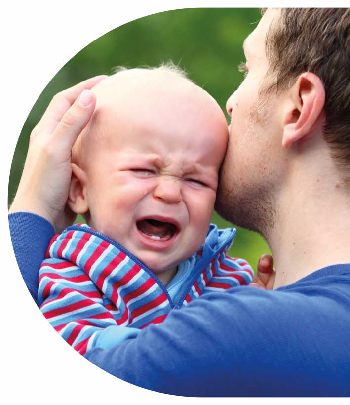 Man holding crying baby
